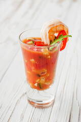 delicious summer gazpacho cocktail on a white wooden rustic background