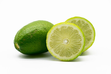 whole and slice green Lemons isolated on white background