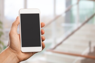 Hand holding modern Smartphone with a blank screen
