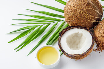 fresh natural coconut and oil on white acrylic background