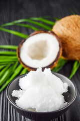 fresh natural coconut butter on black wooden background