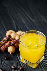 tamarind juice cooling drink on black rustic wooden background tea