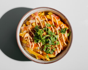 French fries with cheese sauce, greens, bacon top view closeup isolated