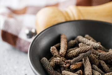dried fragrant pippali long pepper on a stone background