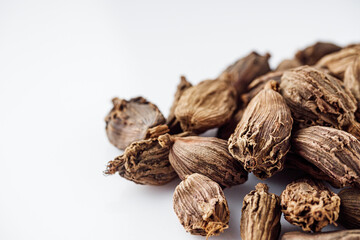 barrel dried black cardamom on a white background