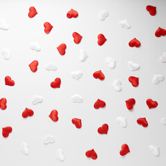 Red and white silk hearts isolated on white background. Valentine's day or Wedding romantic concept, top view, copy space, flat lay