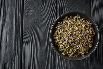 aromatic green dried sage on a black wooden rustic background