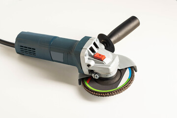 Modern professional angle grinder with a flap wheel on a white background. Power tool for work....