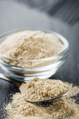 asafoetida aromatic powder on a black stone background