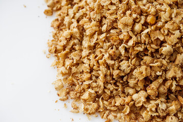 fresh raw buckwheat flakes on a white background
