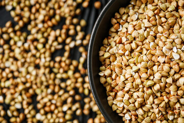 organic raw green buckwheat on a black background