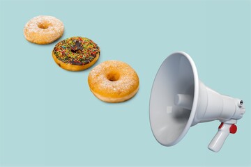 Tasty sweet donuts and big megaphone