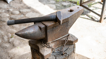 Anvil in the forge and a lot of hammers. Workshop for working with iron. industry
