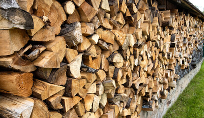 Shed for storing firewood in the village. Wood for heating. Copy space for text, firewood wall