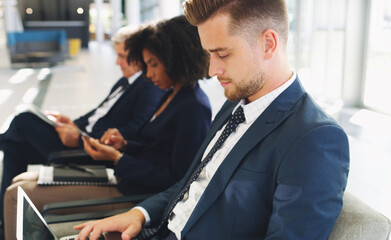 Laptop, hiring and businessman in line for a job interview in corporate global startup company in an office building. Recruitment, diversity and business people waiting for a meeting with management