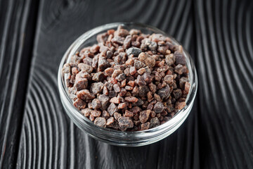 crystalline black Himalayan salt on a black wooden background