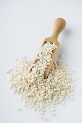 arborio rice for risotto on a white acrylic background
