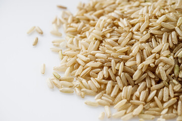 raw unpolished rice on a white acrylic background