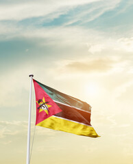 Waving Flag of Mozambique with beautiful Sky.