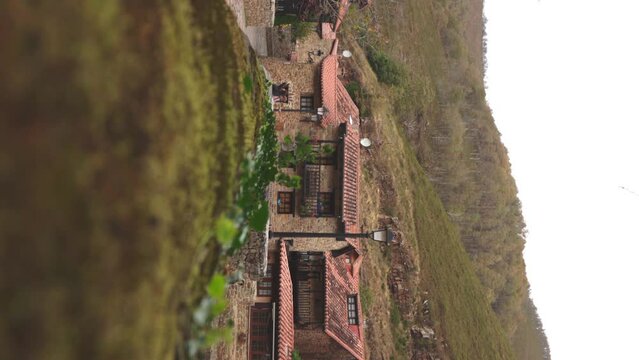 A house in one of the most beautiful villages in Spain, Barcena Mayor, Cantabria, on a windy autumn day. vertical video 