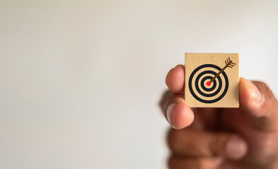 Challenge,Strategy,Focus,Target,objective business concept.,Hand holding wooden cube with Target icon over white background with copyspace use for Goal Achievement idea.
