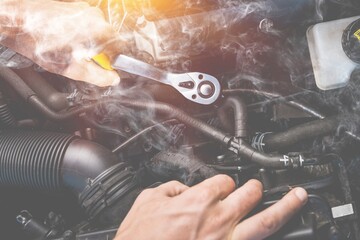 Auto mechanic worker hand with car in garage.