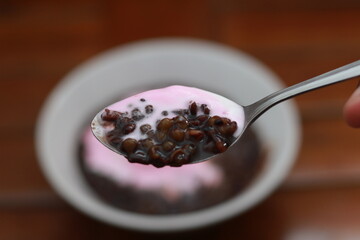 close up of a bowl of black sticky rice porridge