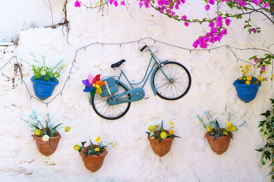 Design and decoration with flower plants in pots. Beautiful house exterior decor with summer flowers idea.