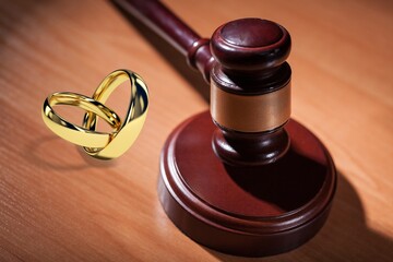 Law concept. Judge wooden gavel and rings on board