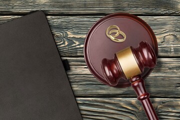 Law concept. Judge wooden gavel and rings on board