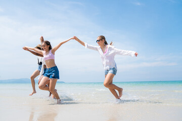 Happy friends at beach party runs together on the beach having fun in a sunny day, Beach summer holiday sea people concept