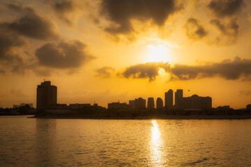 Sunset in Abu Dhabi with skyscrapers silhouetted over the Persian Gulf, UAE