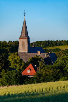 Historic monastery or nonnery &ldquo;Kloster Oelinghausen&ldquo; in Arnsberg Sauerland Germany. Church with bell tower and convent buildings in idyllic rural landscape on a late summer evening with warm sunlight.