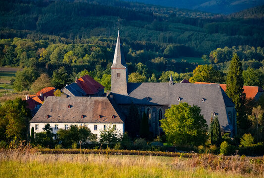 Historic monastery or nonnery “Kloster Oelinghausen“ in Arnsberg Sauerland Germany. Church, convent and farm buildings in idyllic rural landscape on a late summer day with warm sunlight.