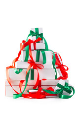 Stack of gift boxes wrapped with red and green ribbons, isolated over white. Clipping path at 400%