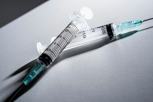 Medical syringes on a white surface