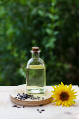 Close-up of sunflower oil in a bottle glass with seeds and sunflower