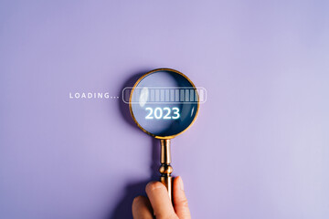 Magnifying glass focus to loading progress 2023 to countdown merry christmas and happy new year...