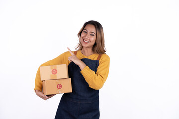 Young Asian woman startup small business freelance holding parcel box and sitting on isolated over the bright white color background, SME Online marketing packing box delivery and isolated concept