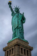 Obraz premium The Statue of Liberty in New York City in a cloudy day.