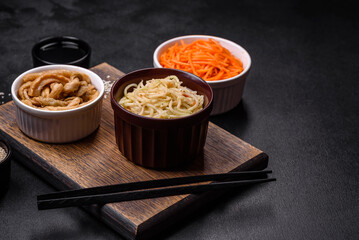 Tasty spicy Korean celery with spices and herbs on a dark concrete background