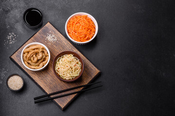 Tasty spicy Korean celery with spices and herbs on a dark concrete background
