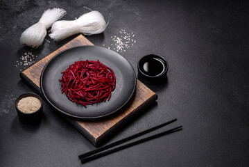 Tasty spicy Korean beet with spices and herbs on a dark concrete background