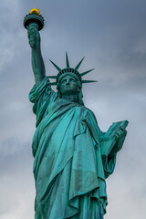 The Statue of Liberty in New York City in a cloudy day.