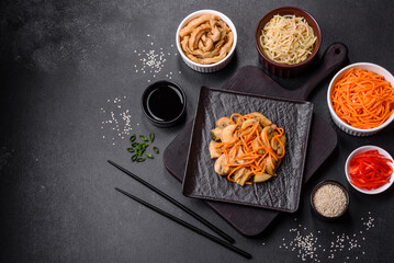 Tasty spicy Korean mushroom with spices and herbs on a dark concrete background