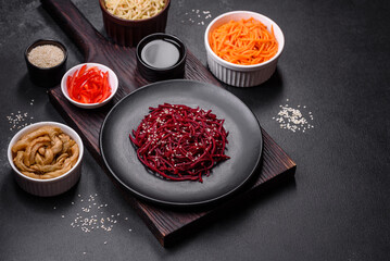 Tasty spicy Korean beet with spices and herbs on a dark concrete background