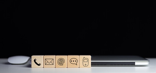 Website page contact us or e-mail marketing concept, Customer support hotline Contact us people connection. Label wood with the email, call phone, address, Chat message icons.