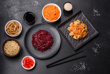 Tasty spicy Korean beet with spices and herbs on a dark concrete background