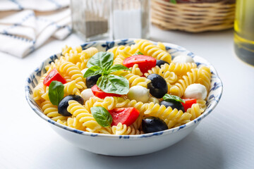 Italian cold pasta salad or Pasta fredda alla caprese. Directly above. Fusilli, tomato, mozzarella, olive, arugula. Turkish name; burgu makarna salatasi