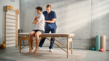 Professional Sport Physiotherapist Working on Specific Muscle Groups and Back Pain with Young Male...